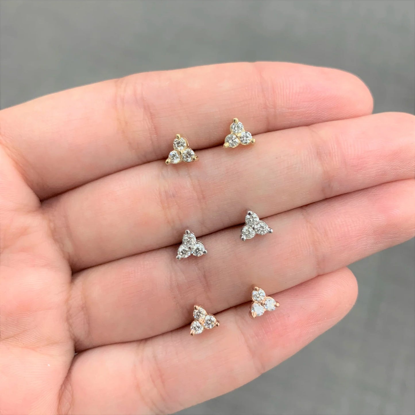 Stud earrings on a hand