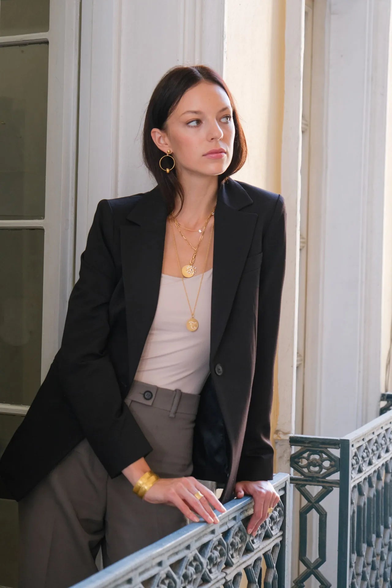 model wearing the gold pendant