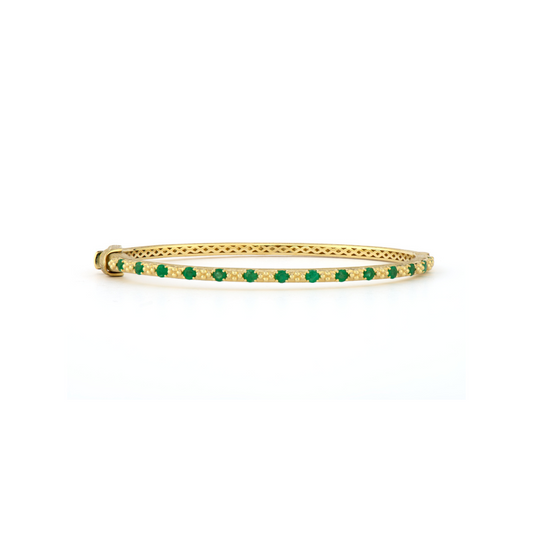 gold bangles with emeralds surrounding