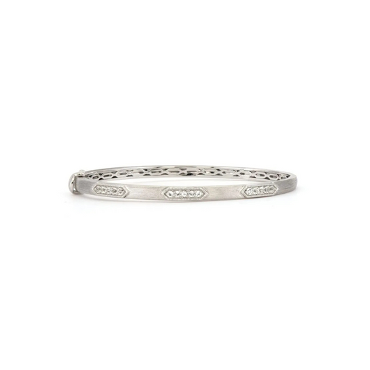 silver bangle with three sets of four diamonds around the band