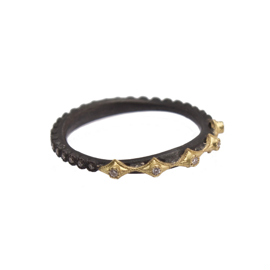 black colored ring with gold and diamonds