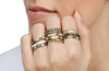 model hand with stacks of rings on most fingers