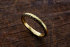 gold band standing up with a brown background