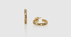 gold and diamond earrings with one laying down 