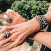 model hands with stack of rings and bracelets