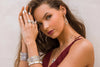 model wearing multiple bangles with rings 