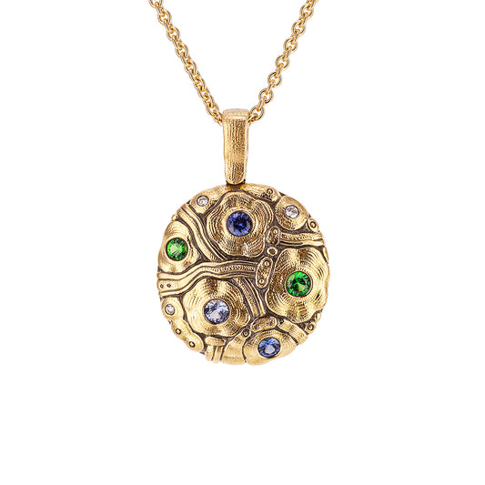 gold pendant with gemstones in a cirlce