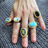 multiple gemstone rings on a model's hand