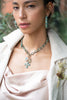 model wearing the pendant on a necklace with other pendants