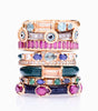 rose gold rings with multiple gemstones stacked on top of each other