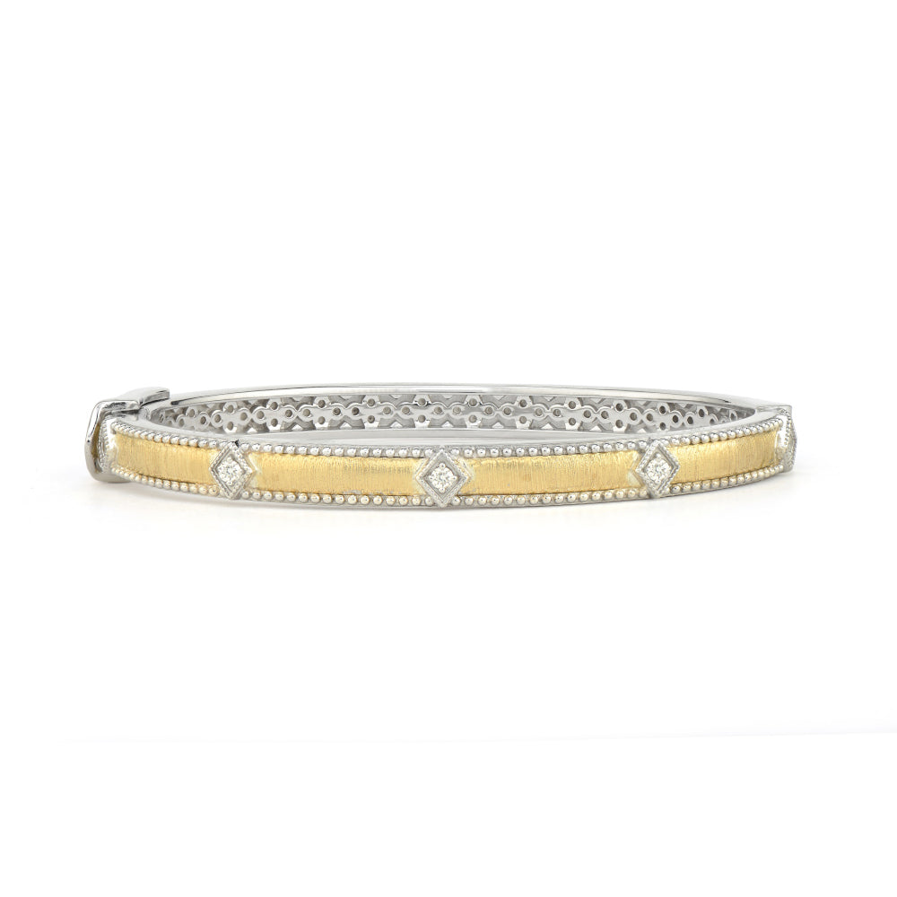 gold bangle with diamond kite shapes around it