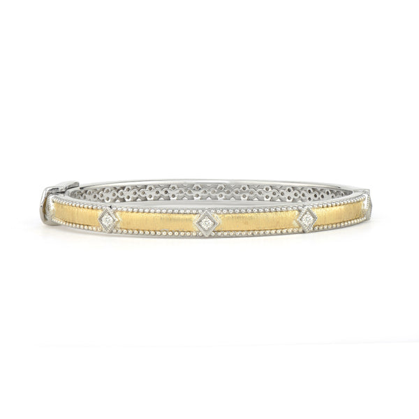 gold bangle with diamond kite shapes around it