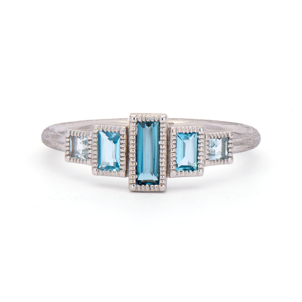 silver band with different colored gemstones